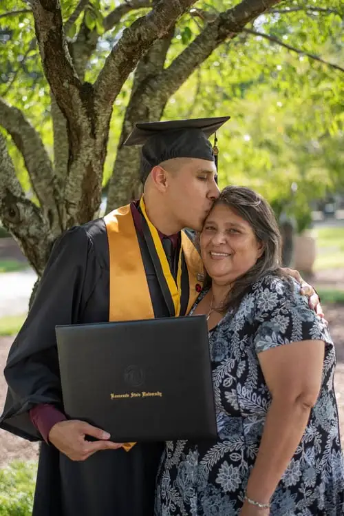 Capture the joy of academic success with a heartfelt graduation moment between a proud son and his mother. Discover inspiring graduation stories and more with CV4Students.