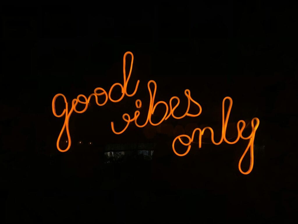 Neon sign glowing in orange with the words 'Good Vibes Only', symbolizing positivity and career confidence. CV Testimonials