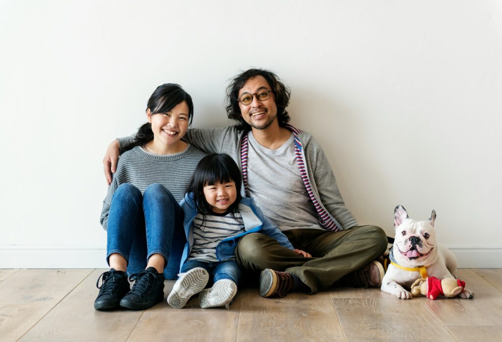 A happy immigrant family starting a new chapter in their life, sitting together with their pet dog, symbolizing hope and a fresh start. Professional CV writing services