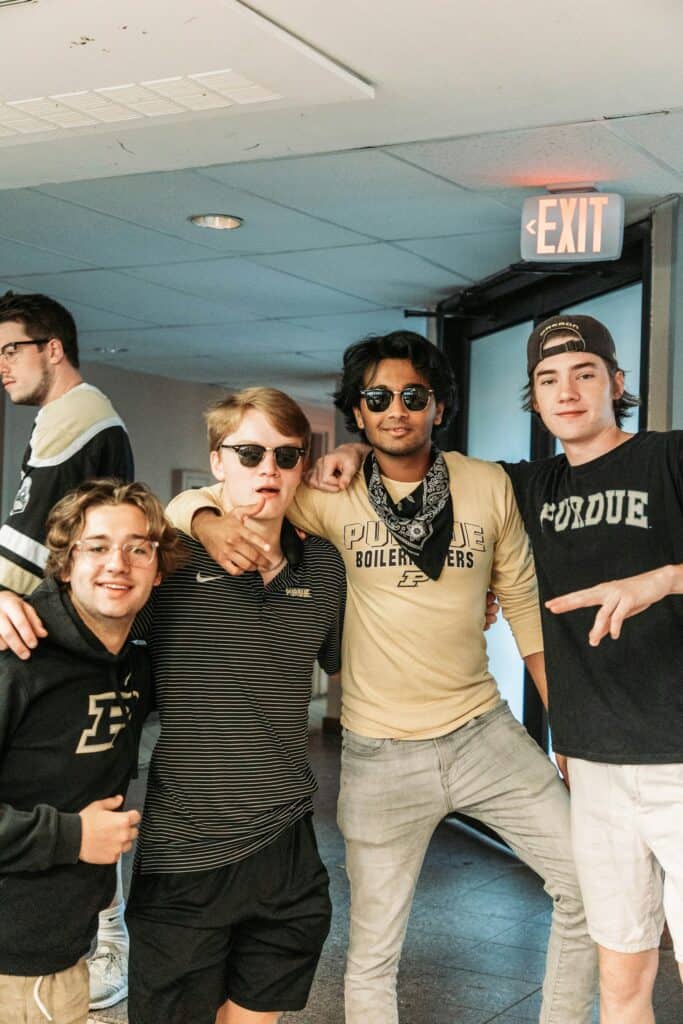 A group of male students enjoying a casual moment together before transitioning from school to the workforce, symbolizing camaraderie and new beginnings.