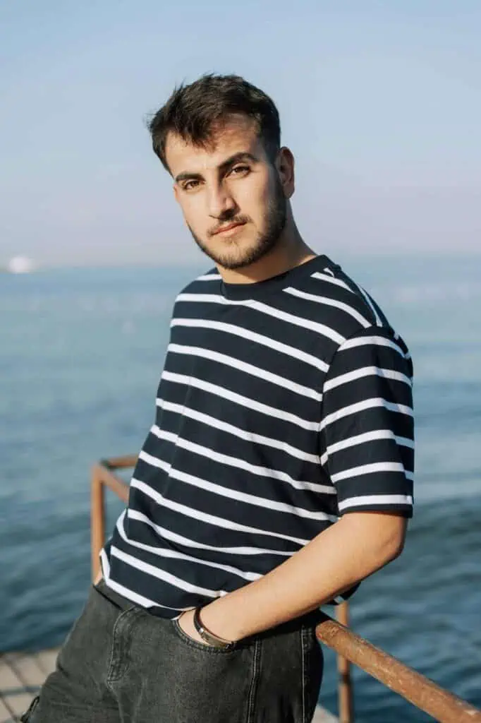 Able seaman posing on dock with calm sea background