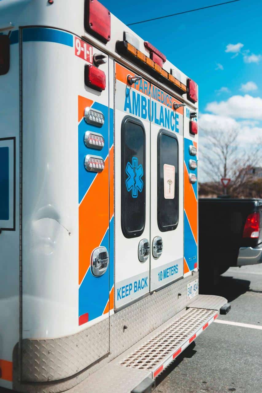 Rear view of an ambulance with emergency markings, representing a career in emergency medical transport.