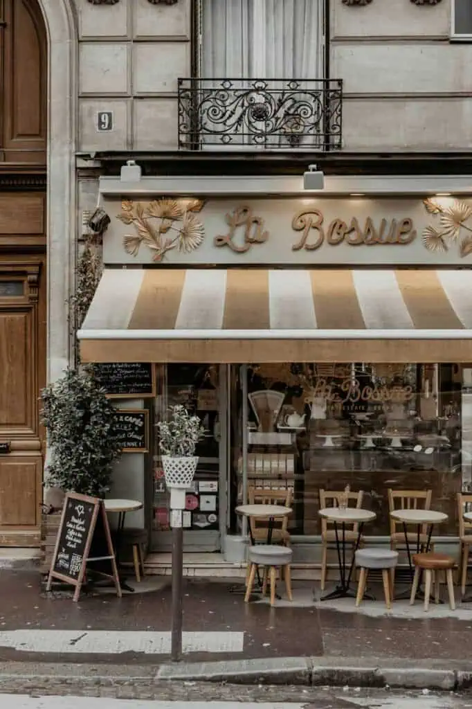 Charming Parisian café with outdoor seating, offering a cozy atmosphere for students and visitors.