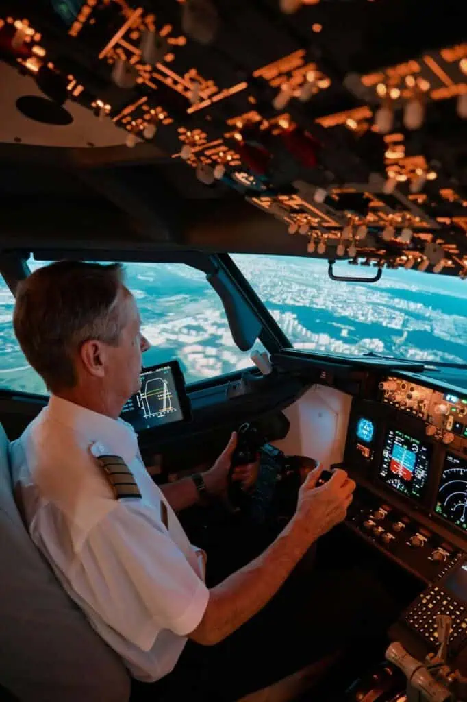 Commercial airline pilot flying aircraft in cockpit during descent