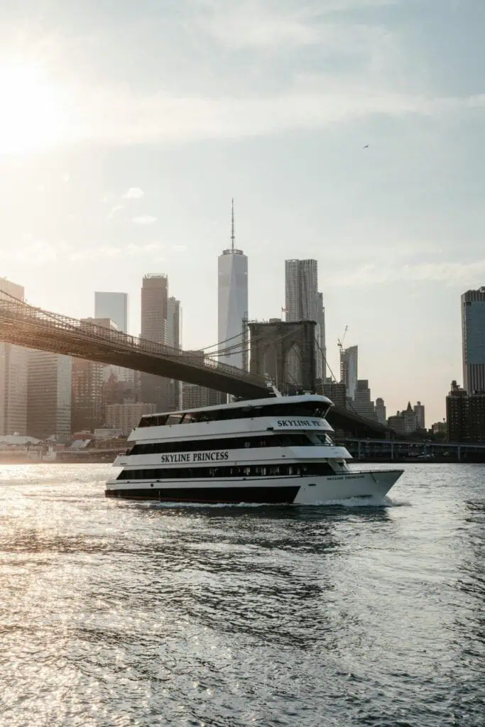 Ferry boat 'Skyline Princess' cruising past Brooklyn Bridge with NYC skyline in background