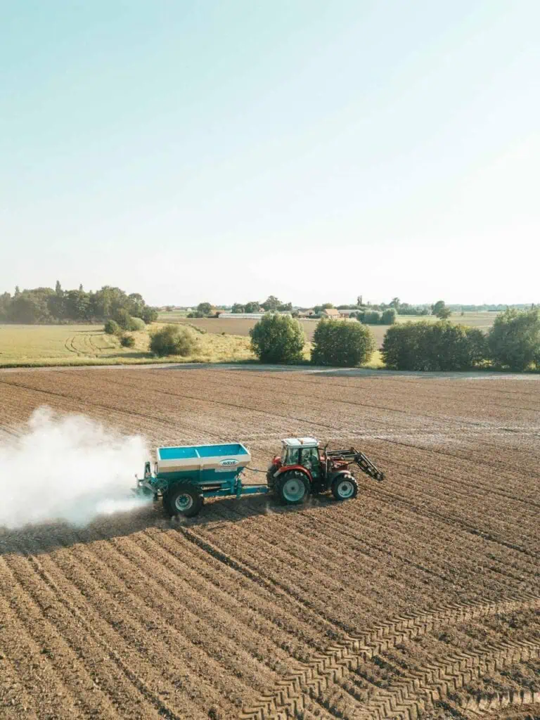 Fertilizer tractor working on a farm field – a growing career path in agricultural sales and product support for students and career changers.