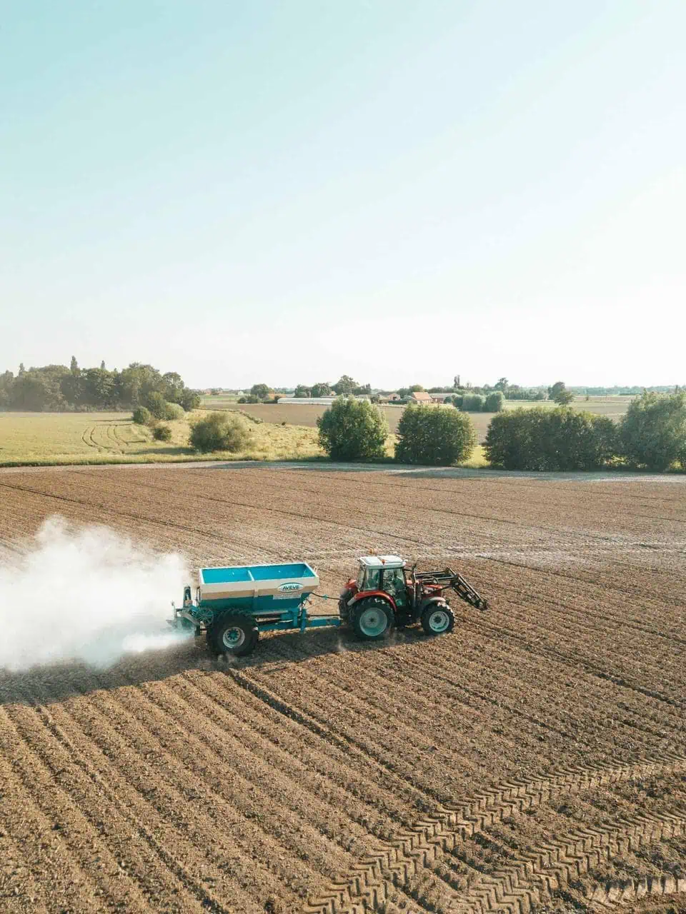 Fertilizer tractor working on a farm field – a growing career path in agricultural sales and product support for students and career changers.