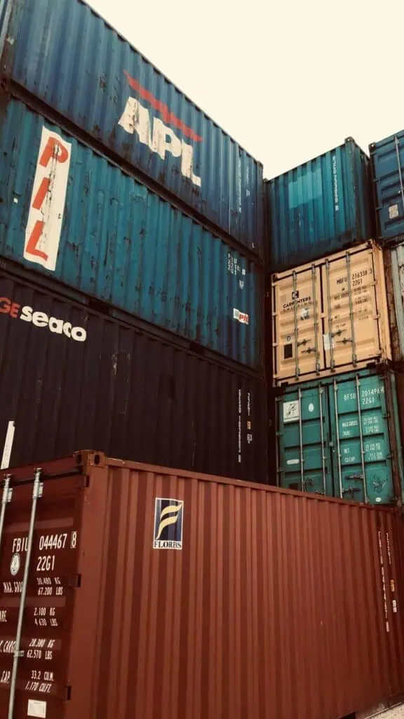 Stacked shipping containers at freight terminal representing logistics coordination