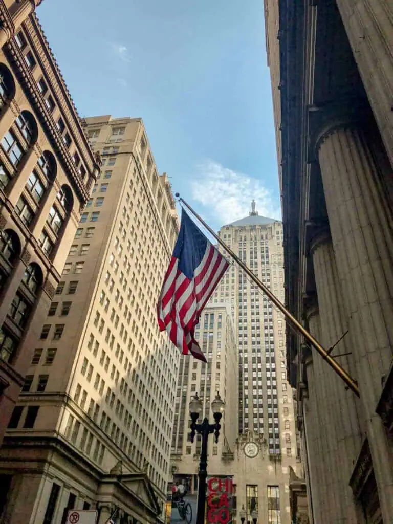 American flag waving in downtown Chicago, symbolizing opportunities for immigrants in the USA.