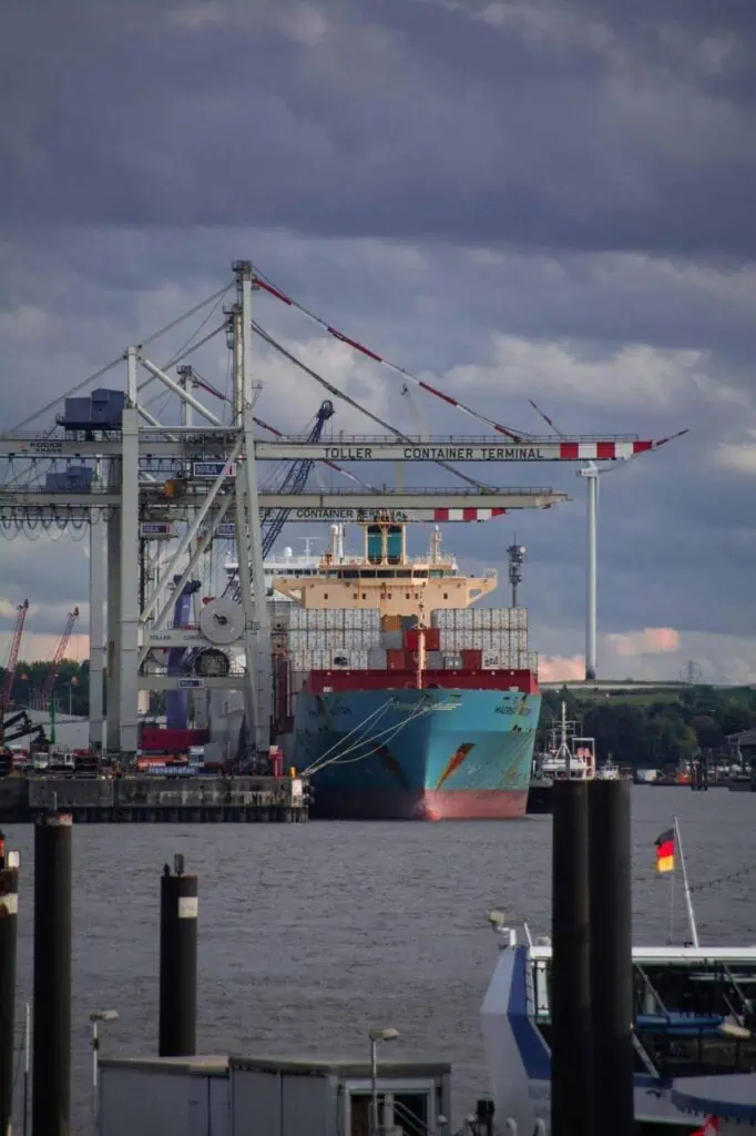 Cargo ship docked at container terminal managed by port operations team