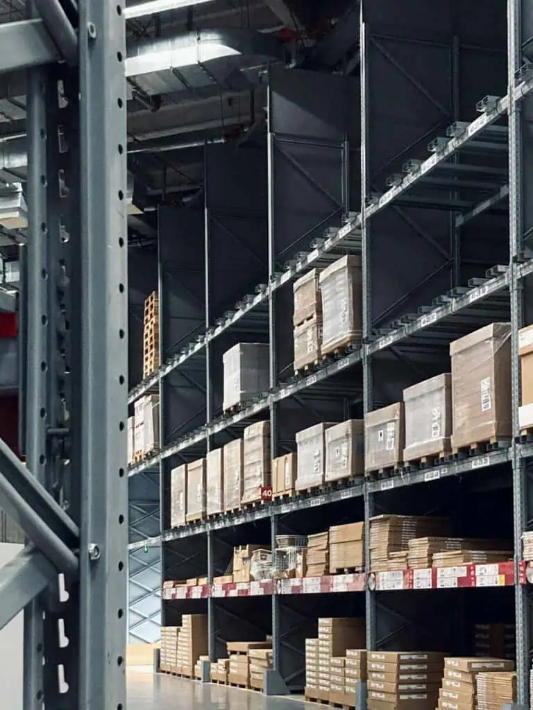 Warehouse racks loaded with pallets and boxes organized for shipping and receiving operations