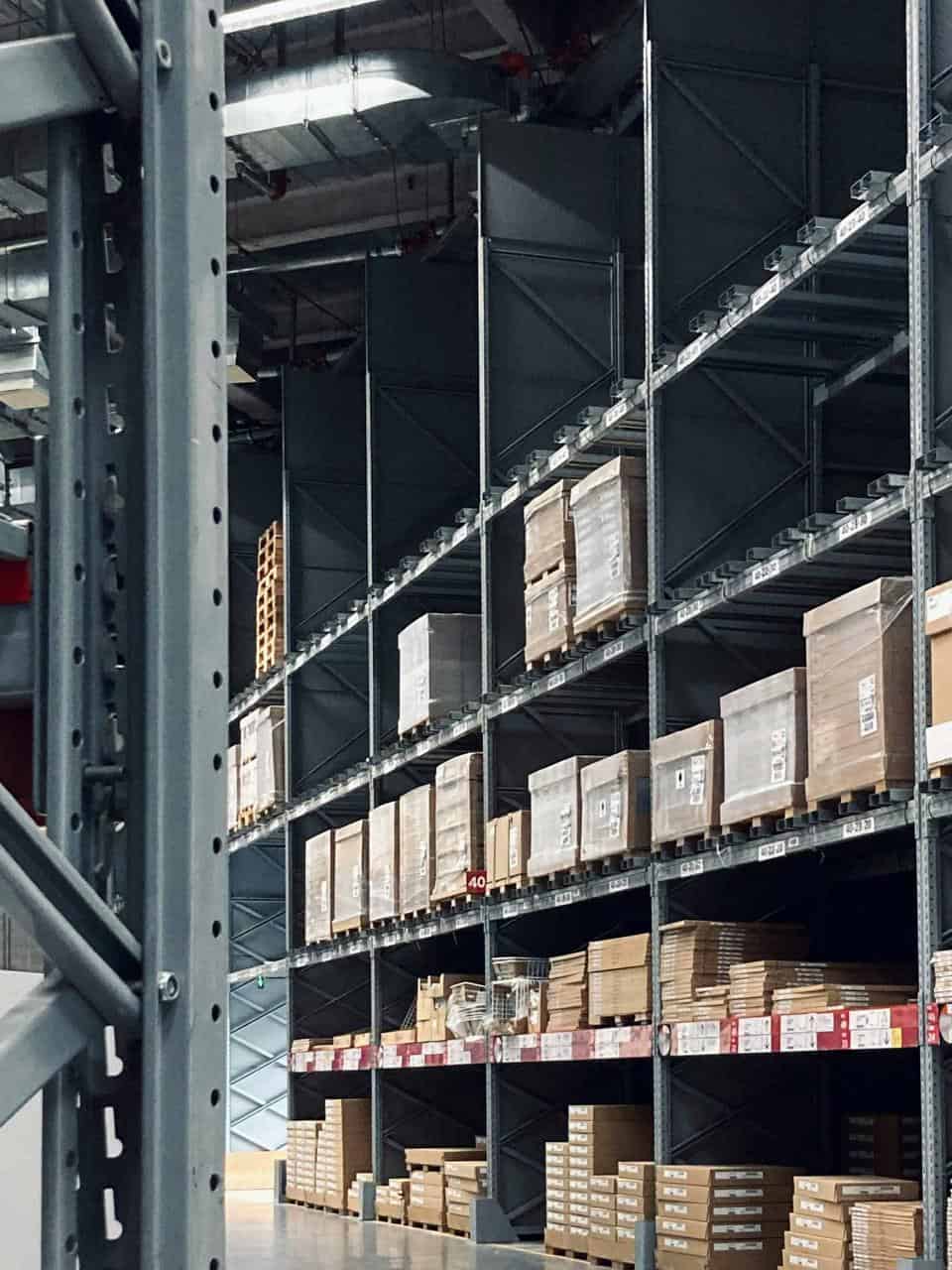 Warehouse racks loaded with pallets and boxes organized for shipping and receiving operations