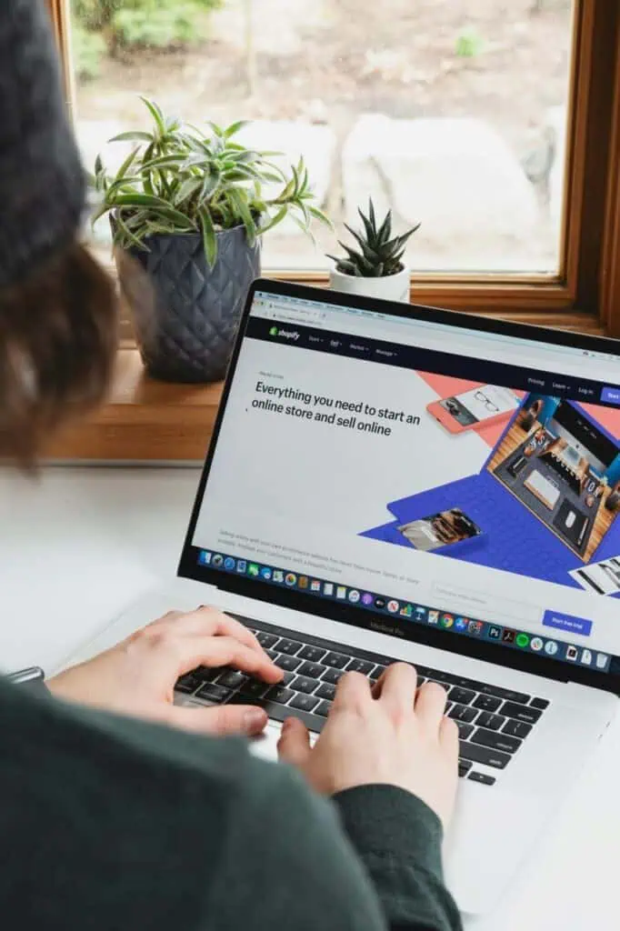 Social media manager working on an e-commerce platform strategy from a laptop