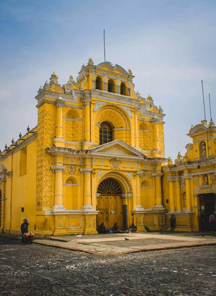 A historic yellow church in Guatemala, showcasing stunning colonial architecture and cultural heritage.