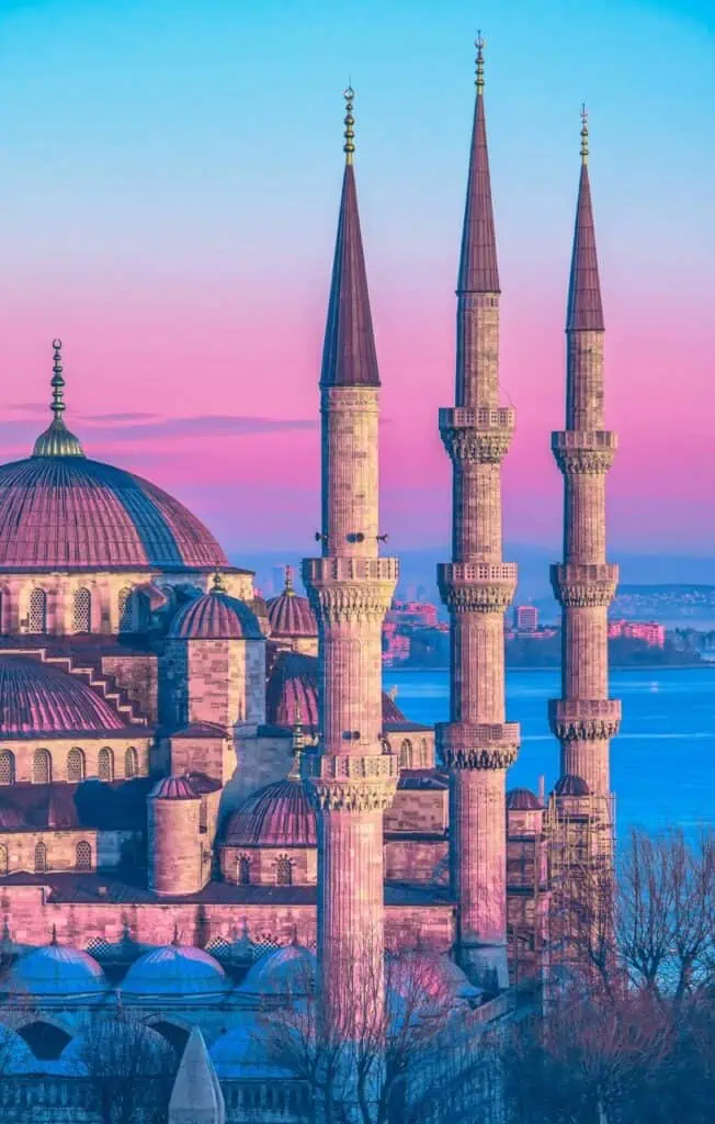 The Blue Mosque in Istanbul, Turkey, bathed in pink sunset hues, symbolizing Turkey’s rich history and cultural heritage.