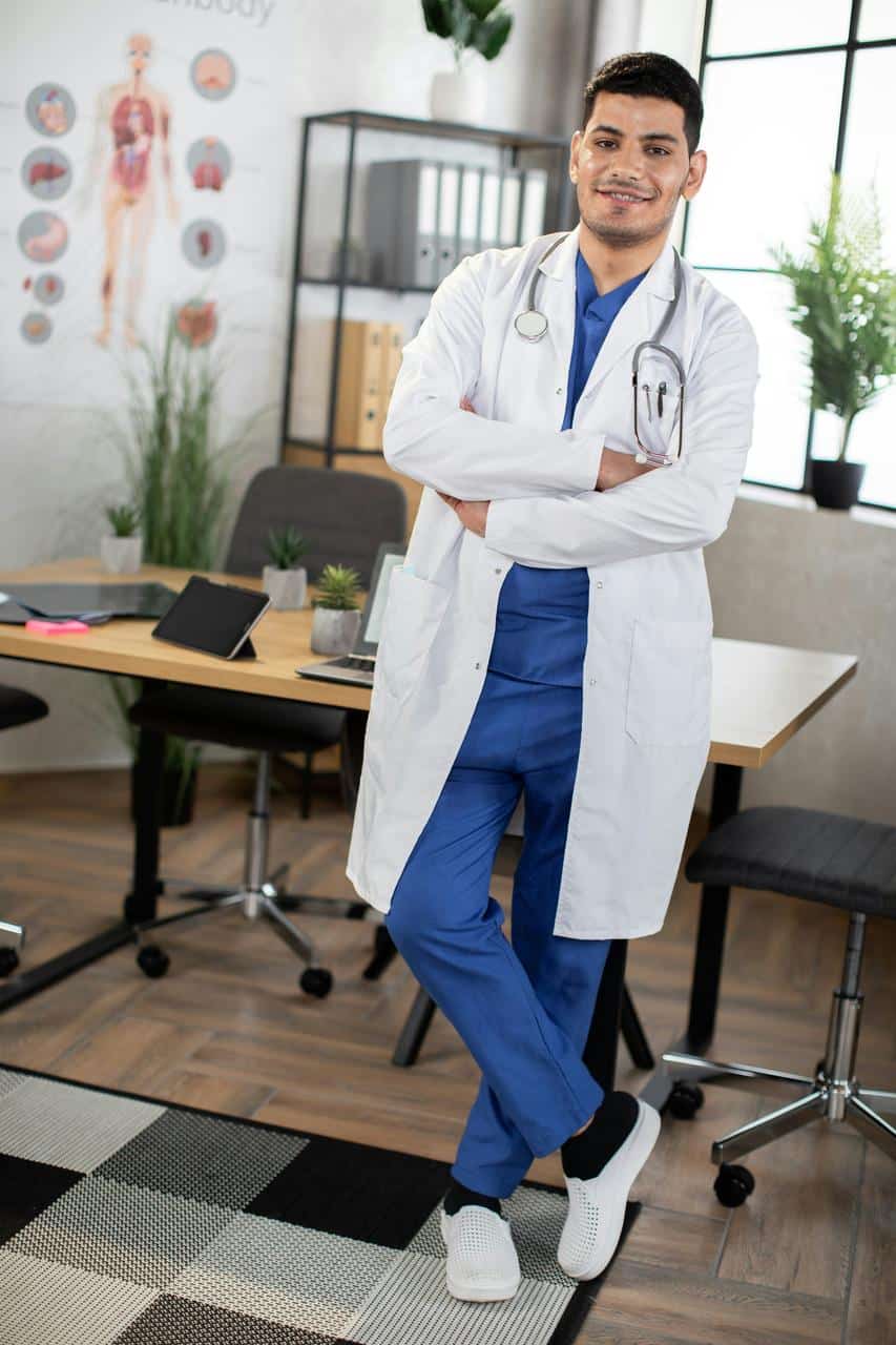A confident endocrinologist in a white lab coat with a stethoscope, standing in a modern medical office, ready to provide hormone and metabolic care.