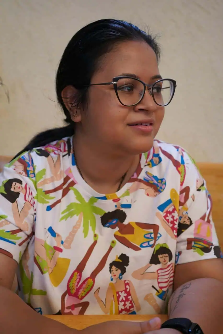Child welfare case manager wearing colorful shirt during client consultation meeting