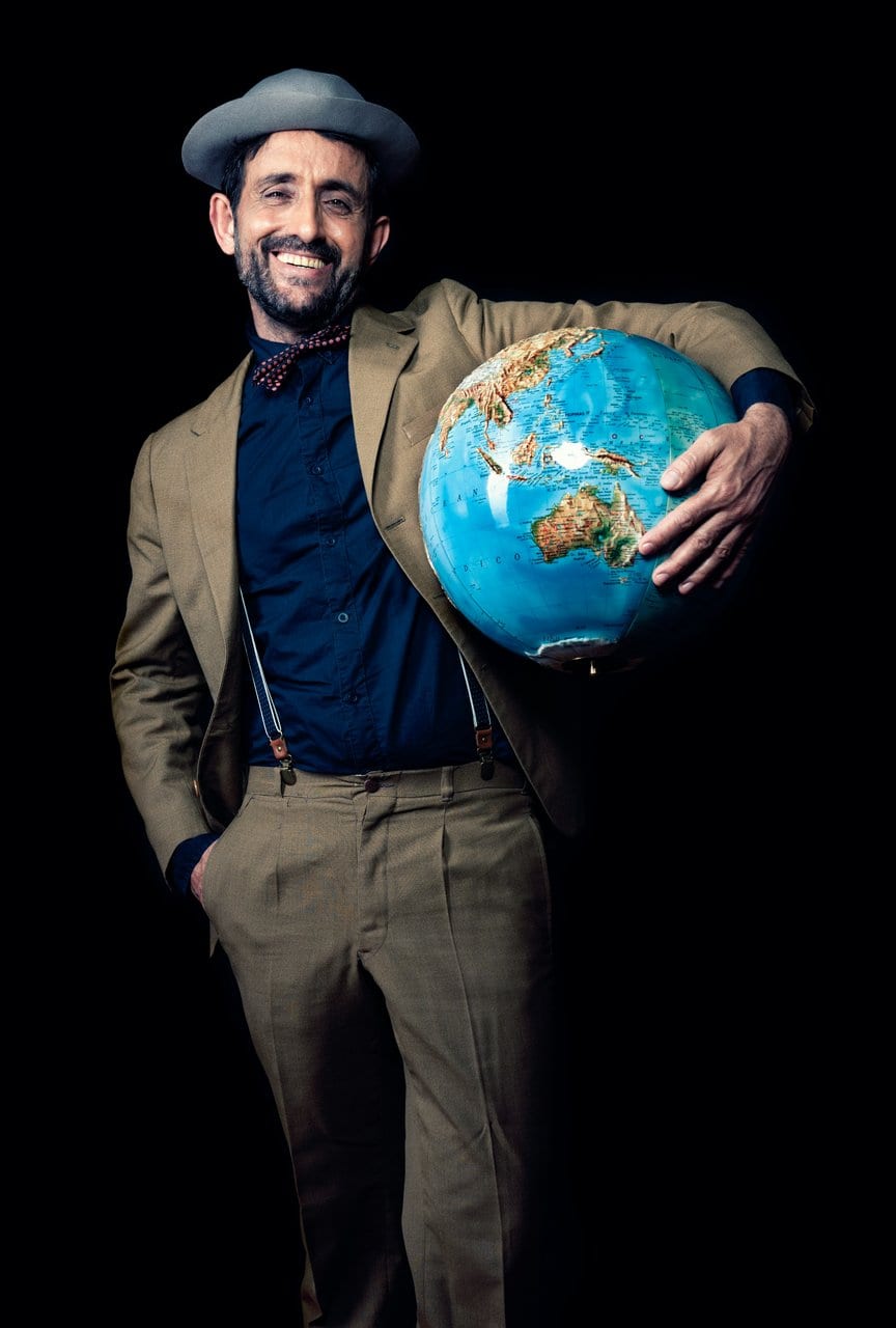 Climate change specialist posing with globe in professional attire