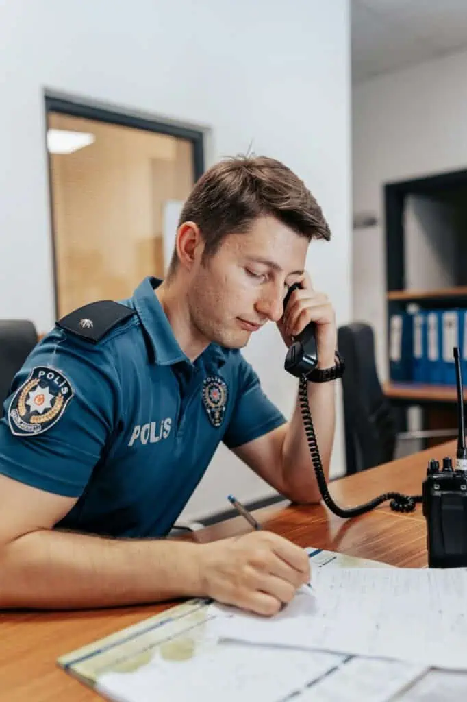 Correctional facility officer completing paperwork at security desk