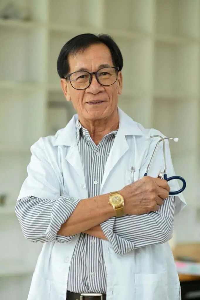 EKG technician wearing white coat and stethoscope in medical facility