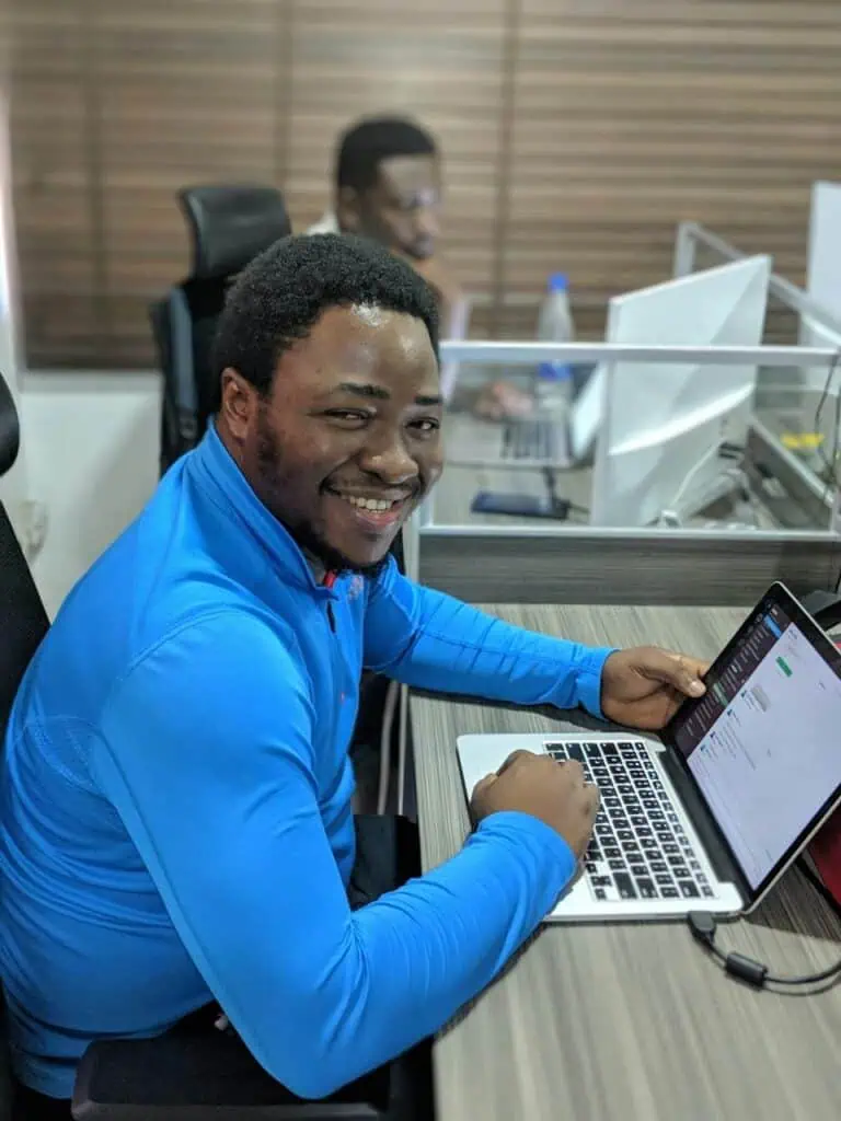 Full-stack developer coding on laptop in modern coworking space