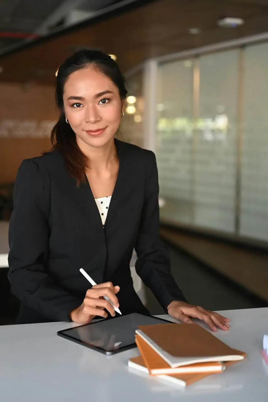 Immigration consultant using digital tablet in modern workspace