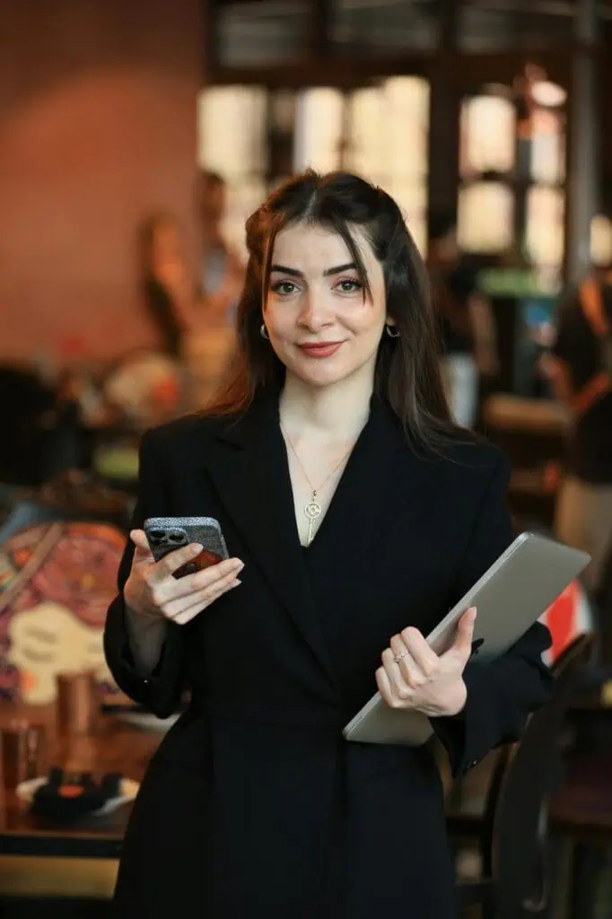 Marketing manager holding tablet and phone in creative workspace