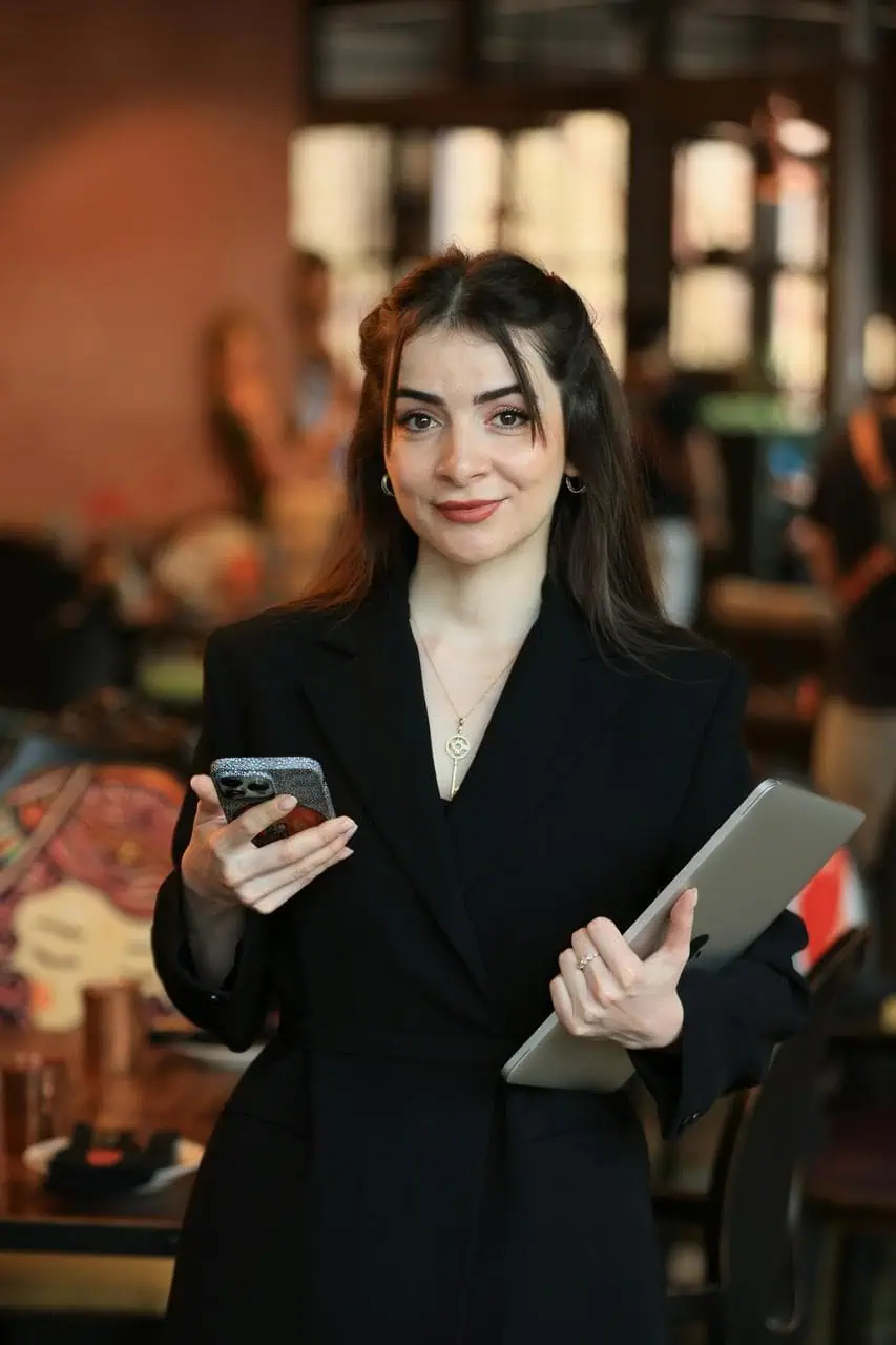 Marketing manager holding tablet and phone in creative workspace