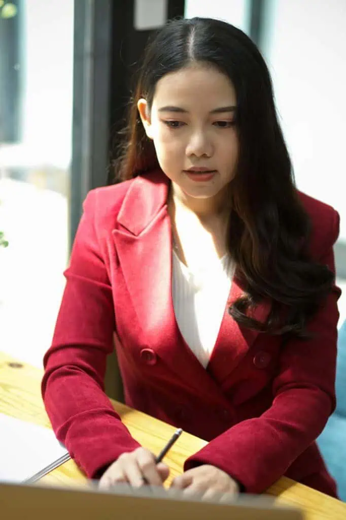 Paralegal working on legal documents at desk in modern office