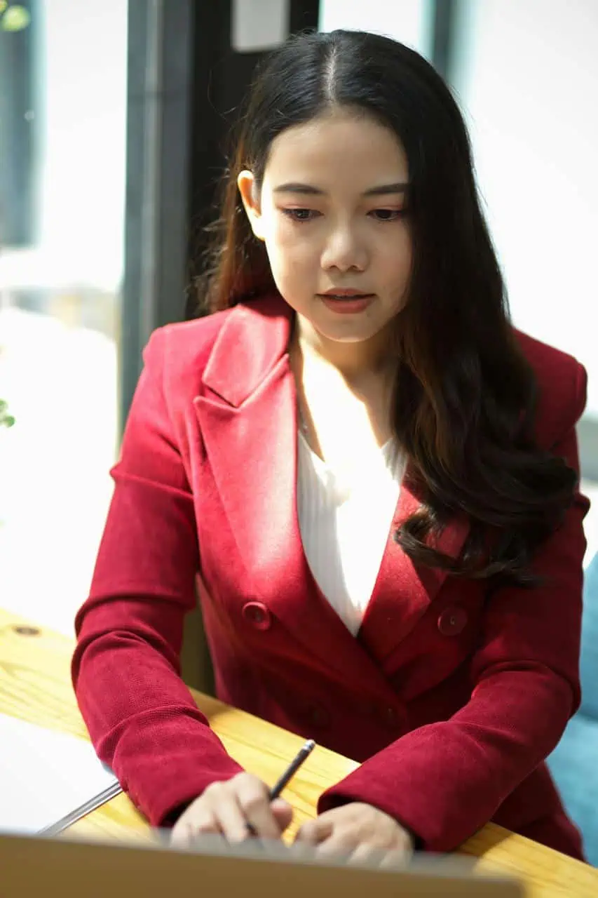 Paralegal working on legal documents at desk in modern office