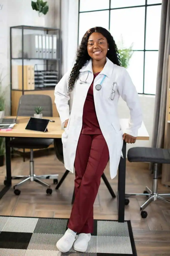 Female psychiatrist wearing white coat and stethoscope in modern medical office